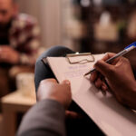Mental health professional writing notes during a psychiatric assessment in Palos Park IL