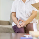 Patient reviewing notes during psychiatric evaluation preparation before appointment