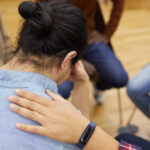 Person receiving emotional support during addiction relapse recovery