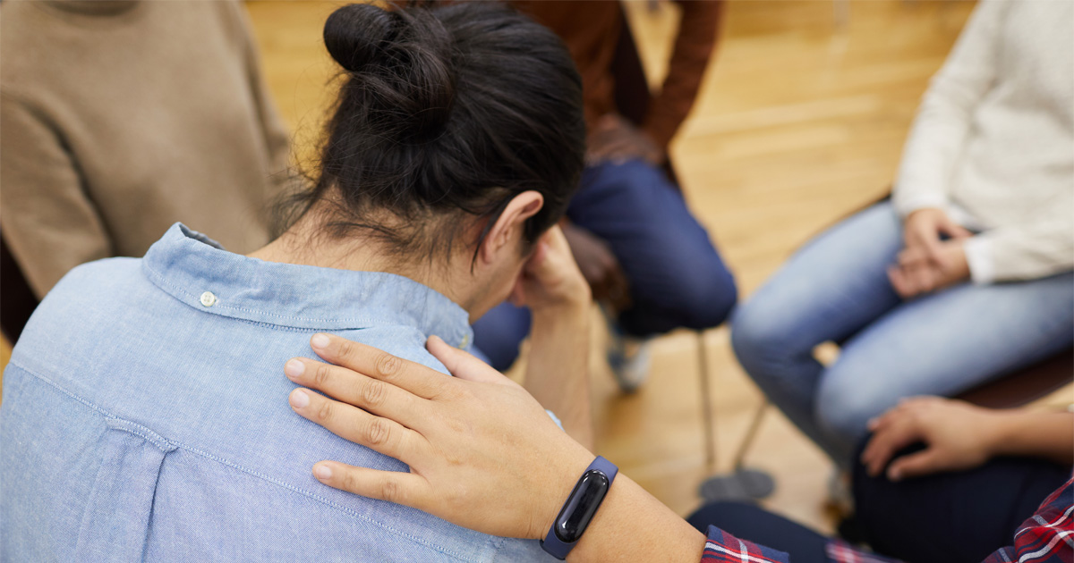 Person receiving emotional support during addiction relapse recovery