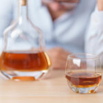 Person showing emotional stress related to High-Functioning Alcohol Addiction while managing daily responsibilities