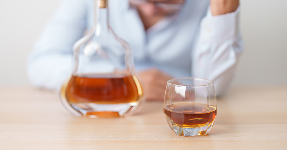 Person showing emotional stress related to High-Functioning Alcohol Addiction while managing daily responsibilities